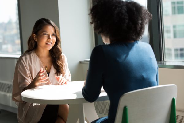 Two women seated having a meeting